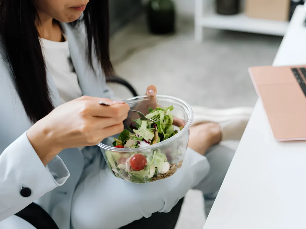 Image of a person eating a salad with several microgreen varieties.