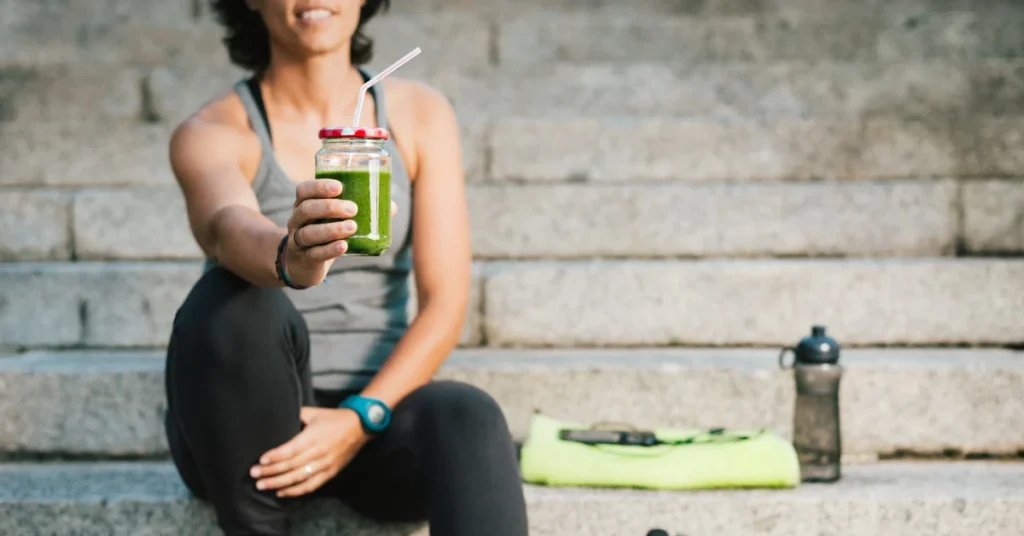 Image of a person drinking the best greens powder for athletes.