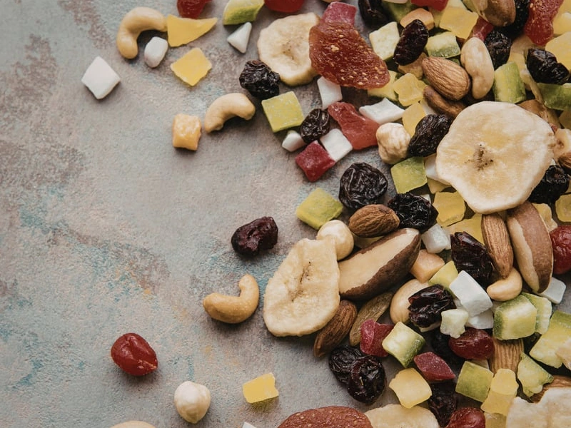 Image of a trail mix with coconut chips and walnuts.