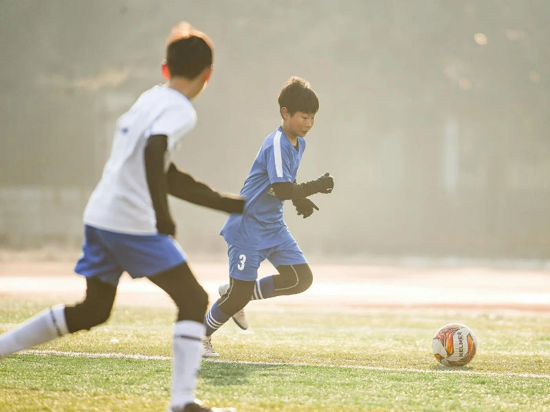 Image of children playing soccer.