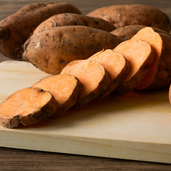 Image showing fresh sweet potatoes on table.