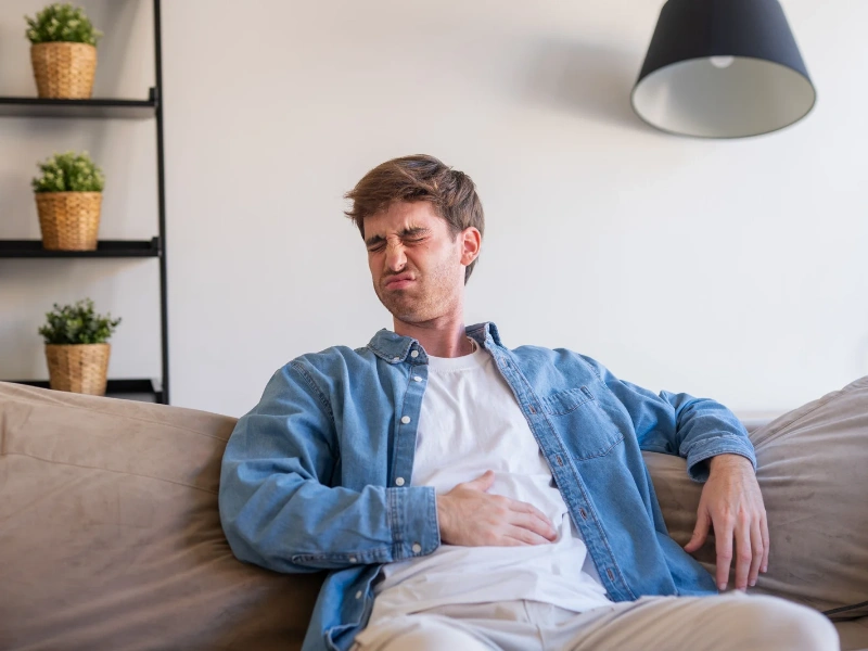 Image showing upset stomach after drinking a greens powder drink.