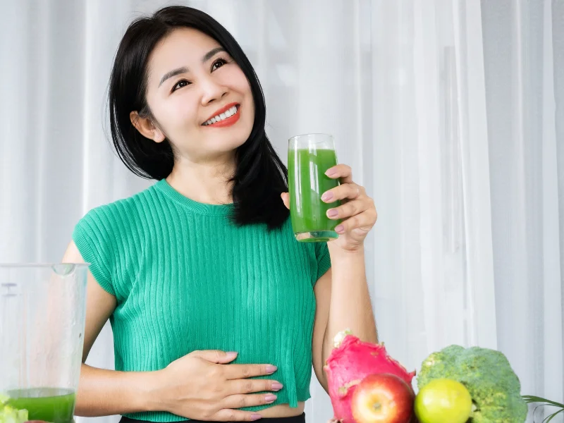 Image of a healthy digestive system concept with greens powder and fresh vegetables.