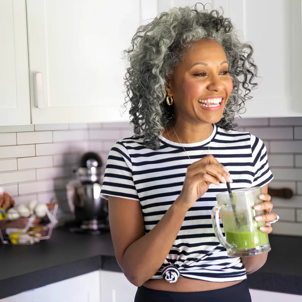 Image of a person drinking a green smoothie.
